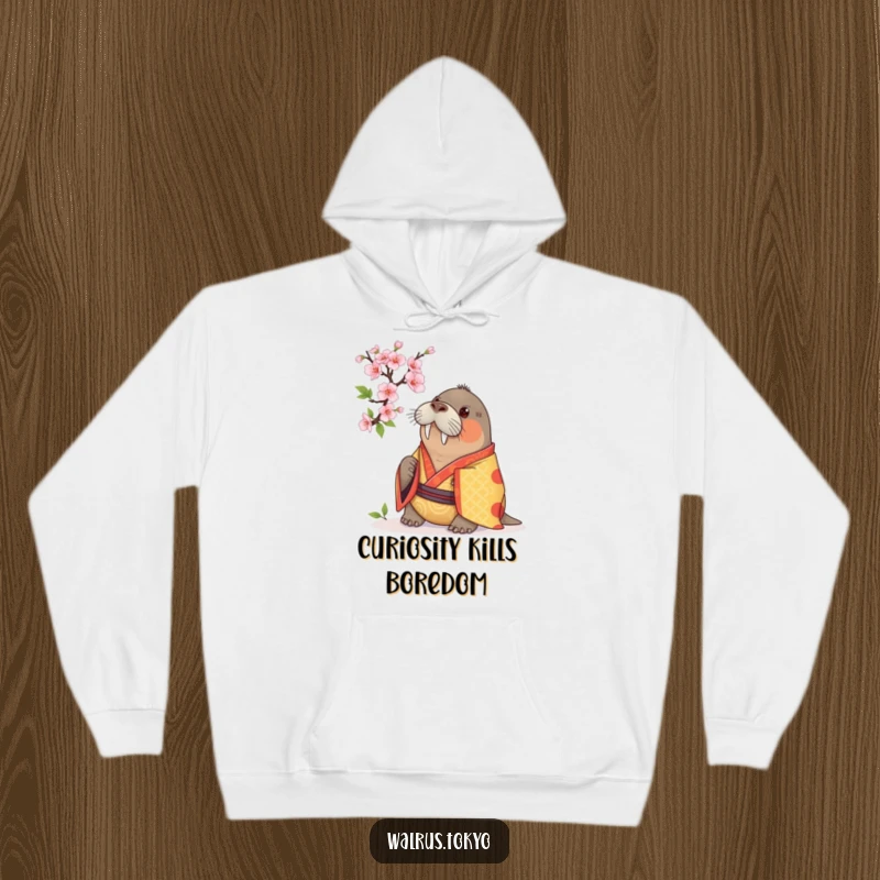 Funny hoodie showcasing a curious walrus in a vibrant kimono, examining a cherry blossom, offering cozy comfort with humorous contemplation.